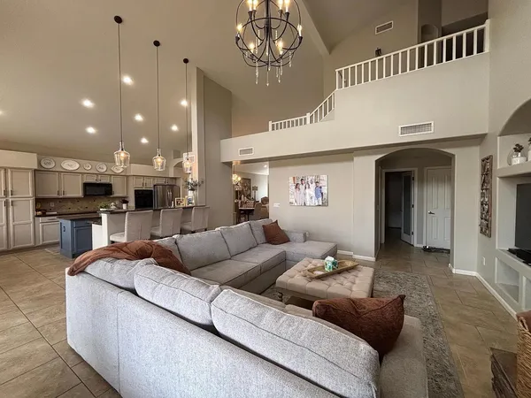 a living room with furniture and kitchen view