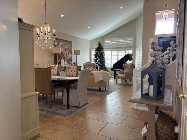 a living room with furniture a chandelier and a chandelier