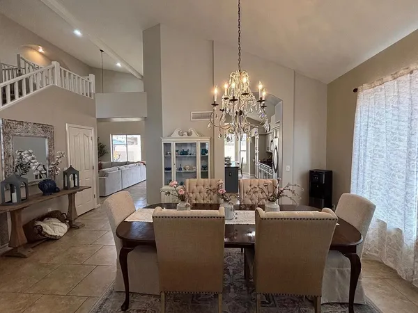 a view of a dining room with furniture and chandelier