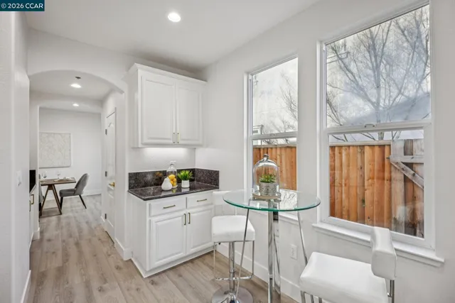 a bedroom with a bed and a view of kitchen