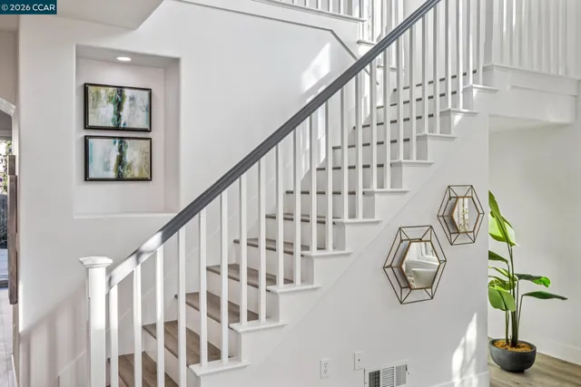 a bathroom with a granite countertop sink a toilet and a bathtub