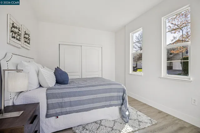 a spacious bedroom with a bed and a view of bathroom