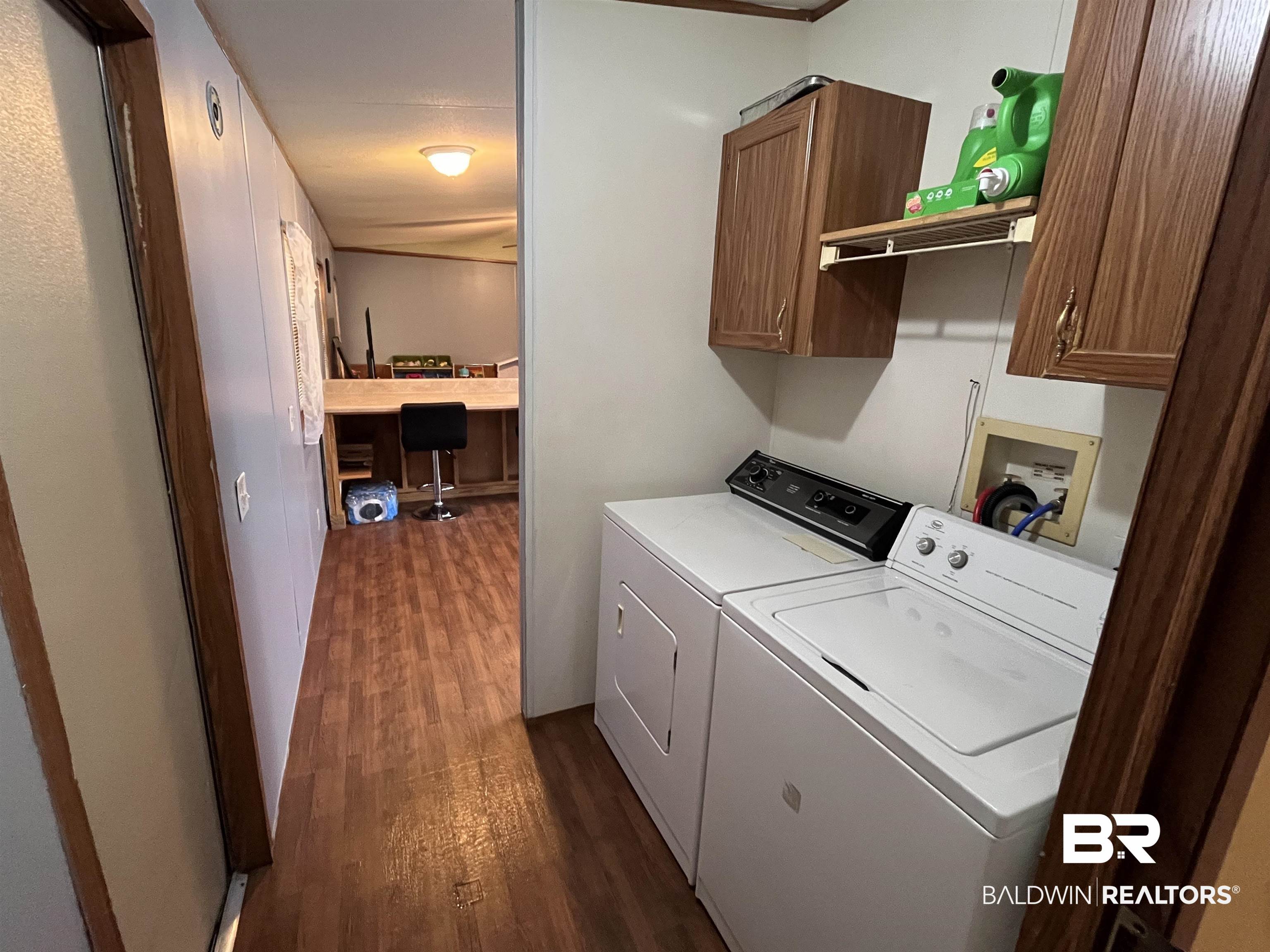 7719 Bermuda Drive Semmes, AL 36575 - Photo 10 of 10 Laundry room featuring cabinet space, and vinyl style floors.