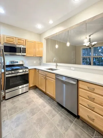 a kitchen with a sink cabinets and stainless steel appliances