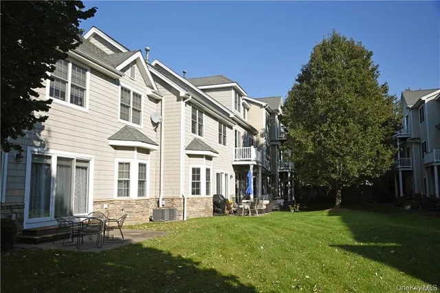a backyard of a house with table and chairs