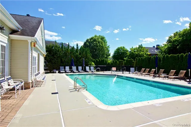 a view of a swimming pool with a patio and a garden
