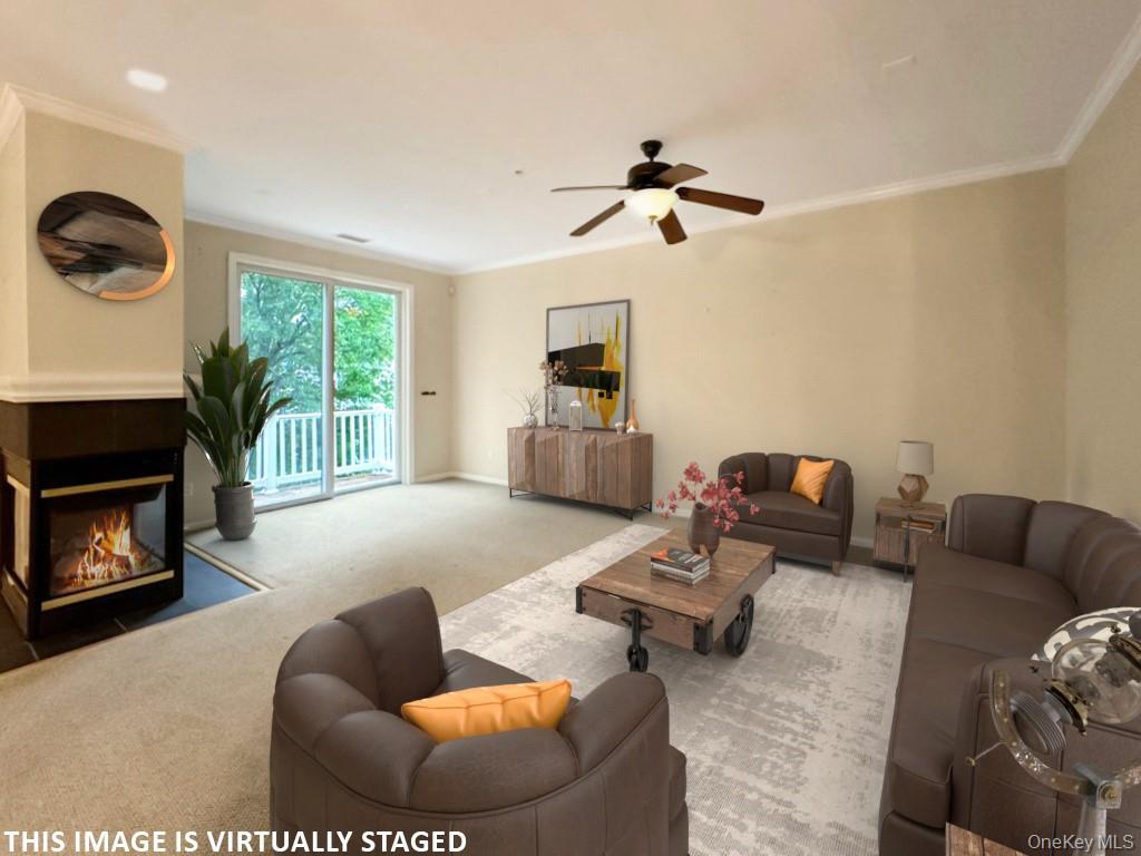2003 Half Moon Bay Drive, Unit 2003 Croton-on-Hudson, NY 10520 - Photo 4 of 33 a living room with furniture and a fireplace