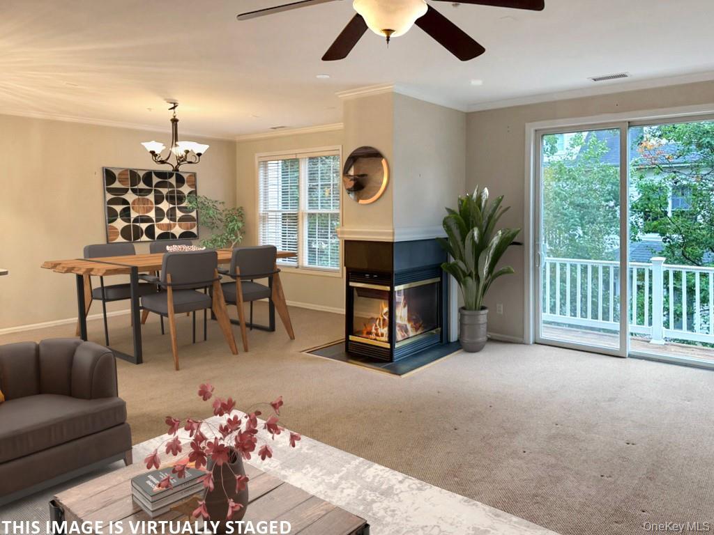 2003 Half Moon Bay Drive, Unit 2003 Croton-on-Hudson, NY 10520 - Photo 6 of 33 a living room with furniture a chandelier and a large window