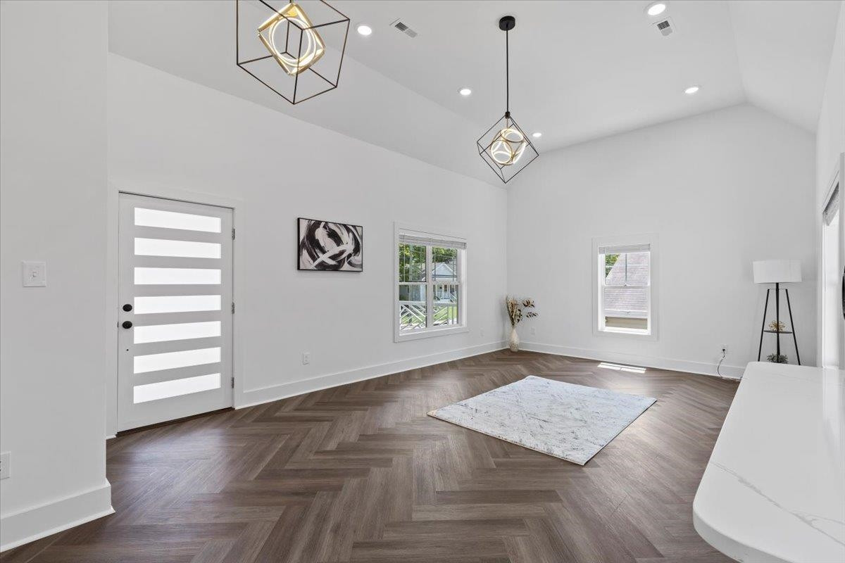 1506 Chapel Hill Road Durham, NC 27701 - Photo 11 of 50 an empty room with wooden floor cabinet and windows