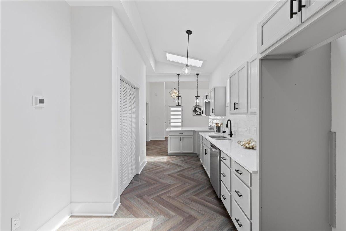 1506 Chapel Hill Road Durham, NC 27701 - Photo 17 of 50 a large white kitchen with stainless steel appliances a sink and a refrigerator