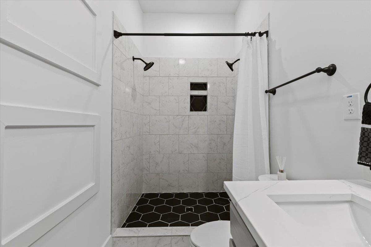 1506 Chapel Hill Road Durham, NC 27701 - Photo 26 of 50 a bathroom with a sink a toilet a shower and a mirror