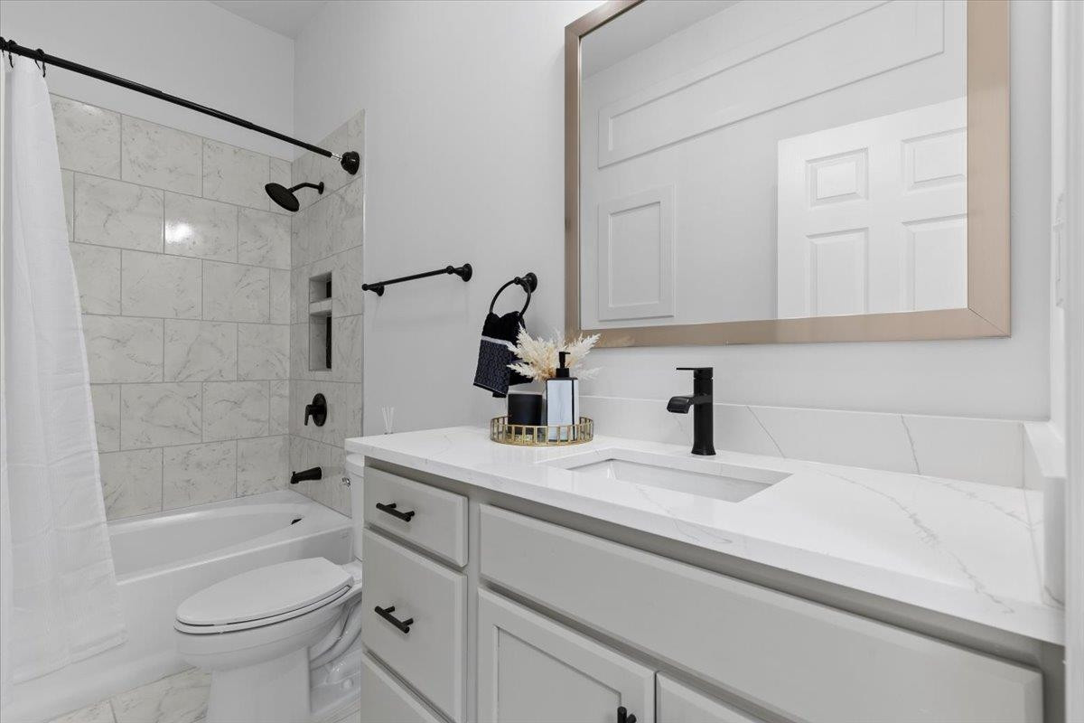 1506 Chapel Hill Road Durham, NC 27701 - Photo 27 of 50 a bathroom with a sink a toilet and shower