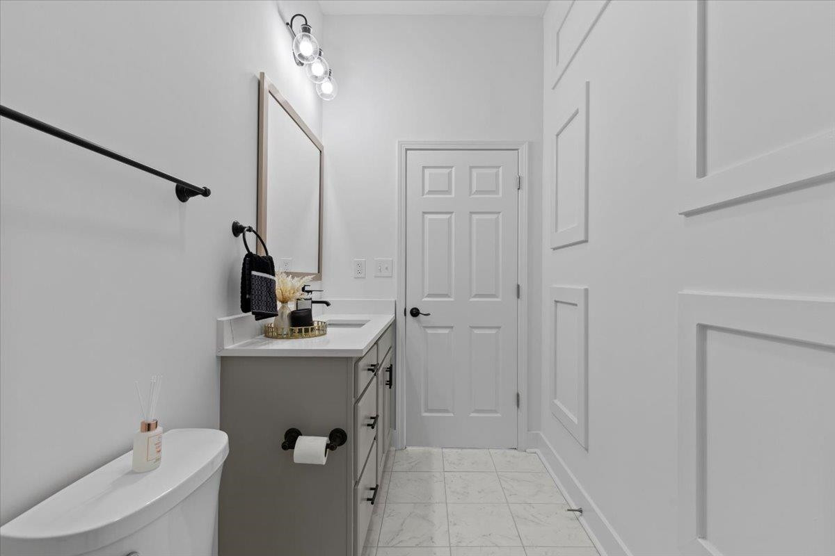 1506 Chapel Hill Road Durham, NC 27701 - Photo 28 of 50 a bathroom with a sink a toilet and mirror