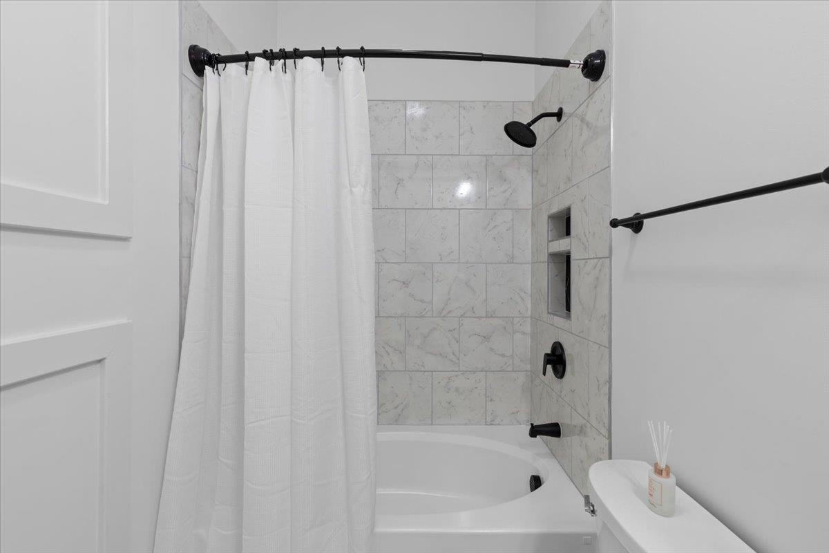 1506 Chapel Hill Road Durham, NC 27701 - Photo 30 of 50 a bathroom with a shower and a bath tub