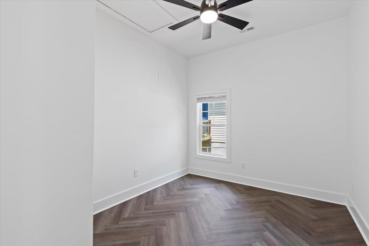 1506 Chapel Hill Road Durham, NC 27701 - Photo 32 of 50 an empty room with wooden floor fan and windows