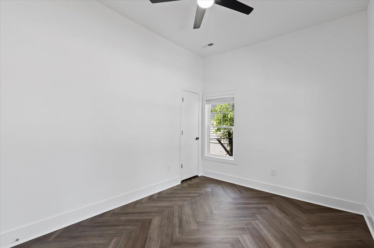 1506 Chapel Hill Road Durham, NC 27701 - Photo 33 of 50 an empty room with wooden floor and exposed radiator