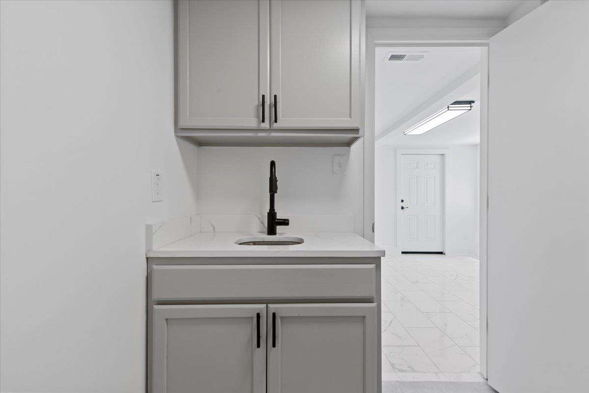 1506 Chapel Hill Road Durham, NC 27701 - Photo 46 of 50 a sink with a vanity and mirror