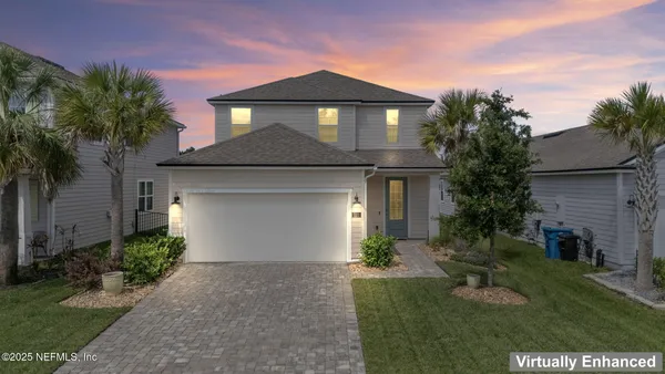 a front view of a house with a garden and plants