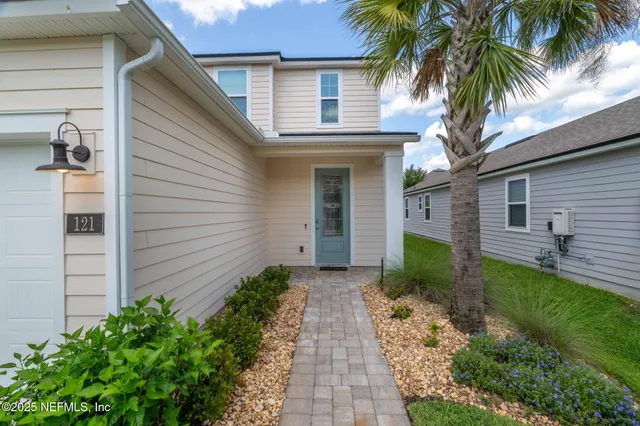 a living room with furniture a wooden floor and a large window