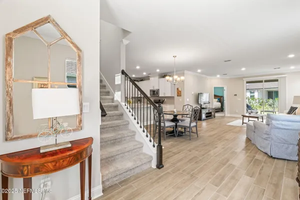 a view of a dining room with furniture and wooden floor