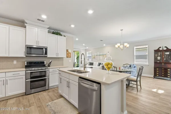 a kitchen with stainless steel appliances a refrigerator and stove