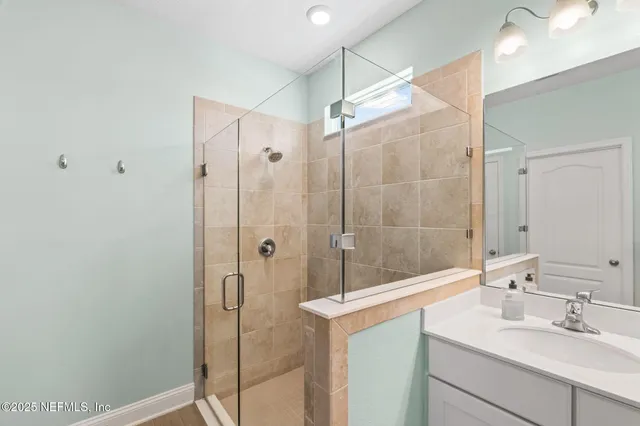 a living room with furniture flat screen tv and a large window