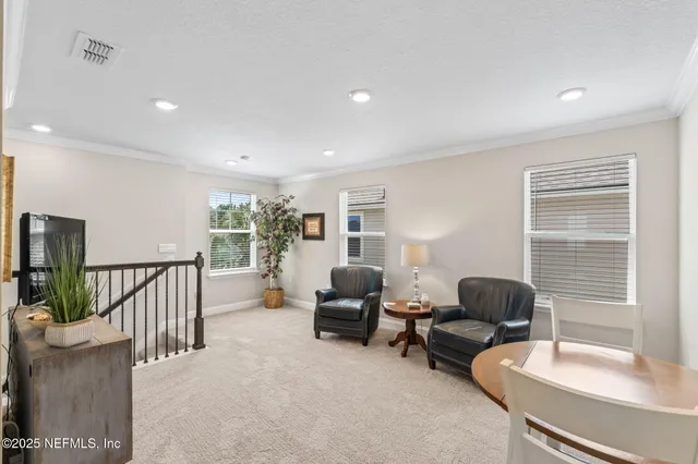 a bedroom with furniture and a fan