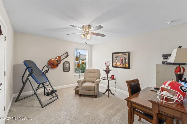 a living room with furniture and a floor to ceiling window