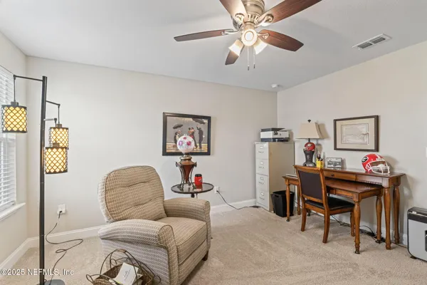 a view of a chair and tables in the backyard of the house