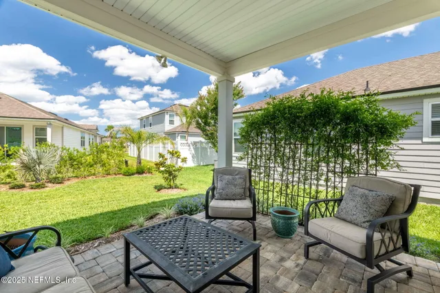 a view of a house with a big yard and a large tree