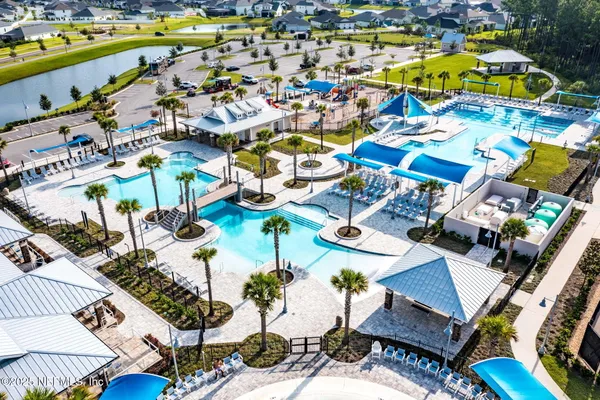 a front view of a house with a garden and plants