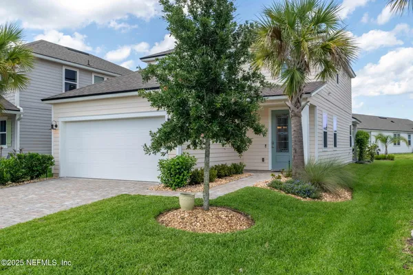 a front view of a house with a garden