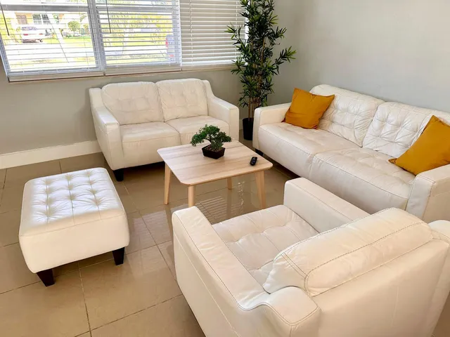 a living room with furniture and a potted plant