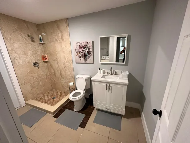 a bathroom with a toilet and a shower curtain