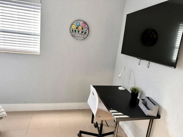 a bedroom with two beds and a window