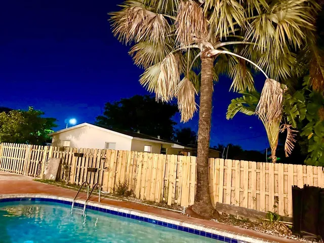a table chair sitting in a small bathroom next to a window