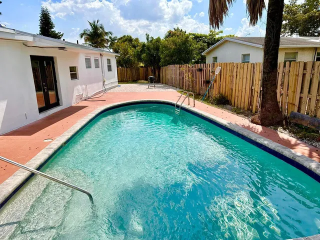 a backyard of a house with table and chairs