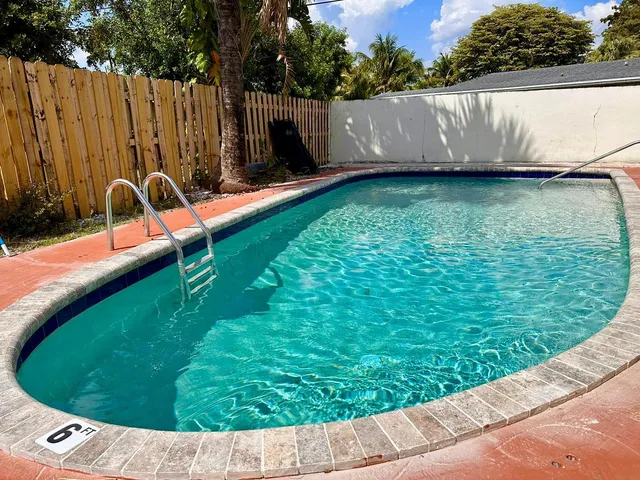 a view of a swimming pool with a back yard