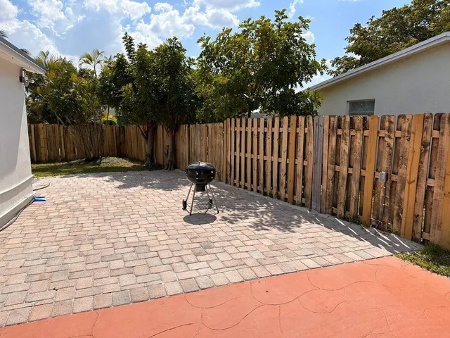 a view of a backyard with wooden fence