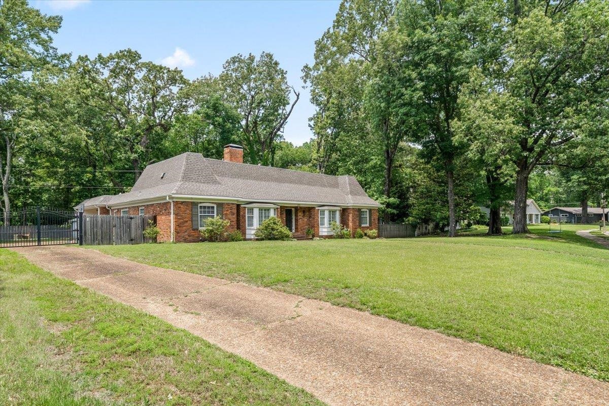 1273 Brookfield Road Memphis, TN 38119 - Photo 3 of 40 Brick exterior residence featuring a gabled roof, bay windows, and a prominent chimney; electric iron gate