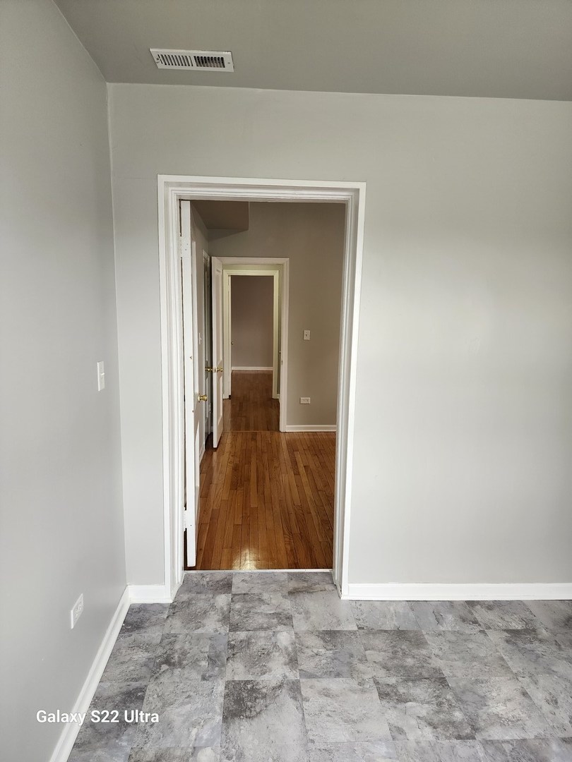 7823 South Evans Avenue, Unit 2 Chicago, IL 60619 - Photo 13 of 13 a view of a hallway with wooden floor and a hallway