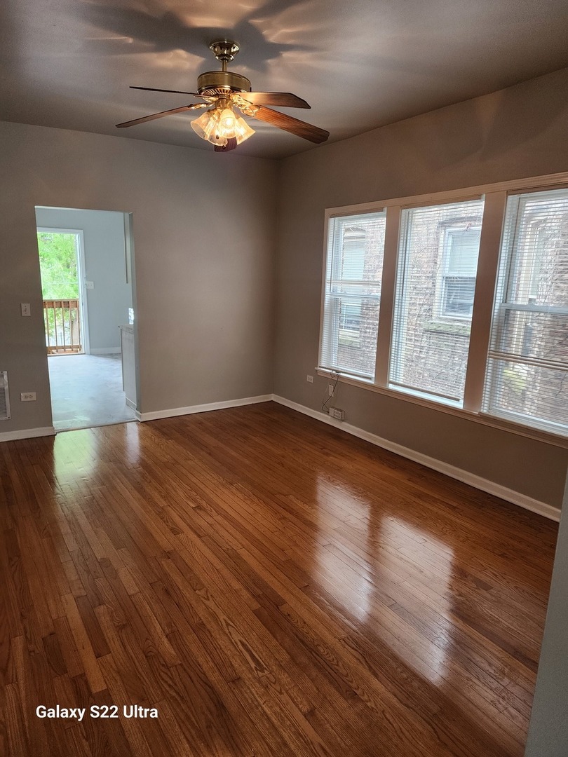 7823 South Evans Avenue, Unit 2 Chicago, IL 60619 - Photo 5 of 13 a view of empty room with wooden floor and fan