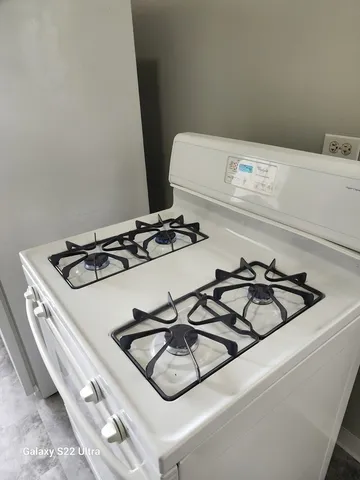 a close view of a stove a microwave and door