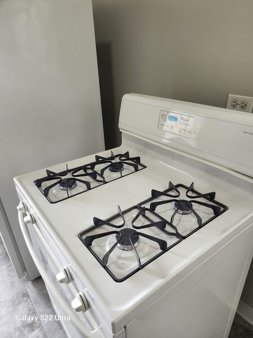 7823 South Evans Avenue, Unit 2 Chicago, IL 60619 - Photo 7 of 13 a close view of a stove a microwave and door