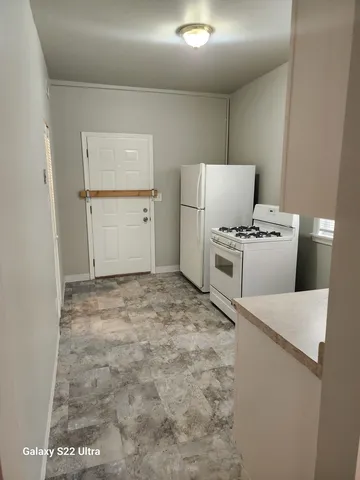 a kitchen with a stove and a refrigerator