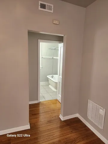 a view of a bathroom with wooden floor