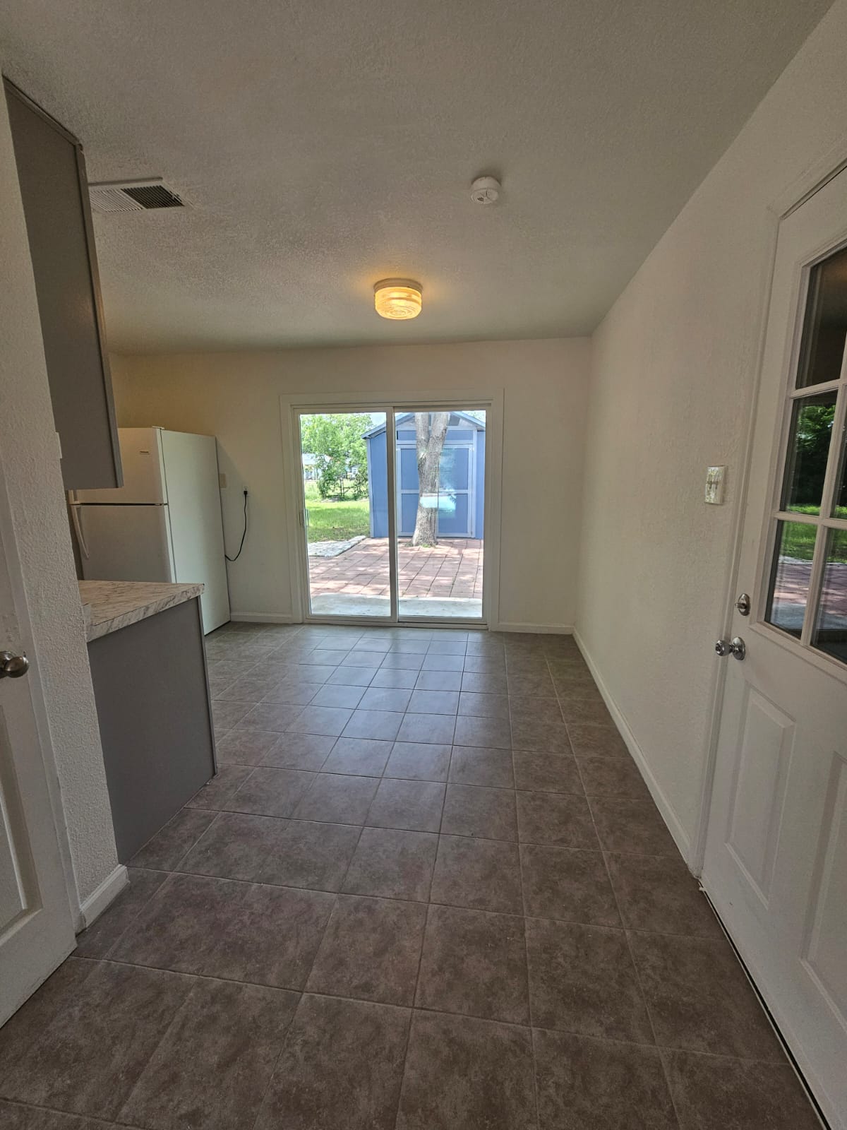 1401 Trinity Street Lockhart, TX 78644 - Photo 6 of 31 Kitchenette featuring a light-toned countertop, gray base cabinetry, and a single-door refrigerator