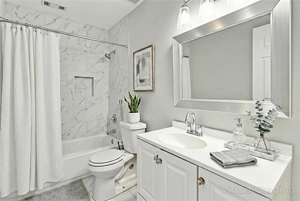 2119 Tudor Castle Way Decatur, GA 30035 - Photo 10 of 35 a bathroom with a sink a toilet and shower