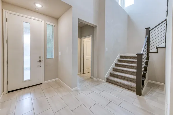 a view of a bathroom with staircase and white walls