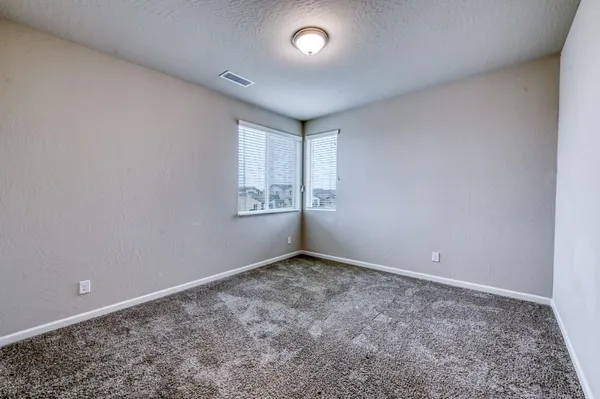 an empty room with a empty space and windows